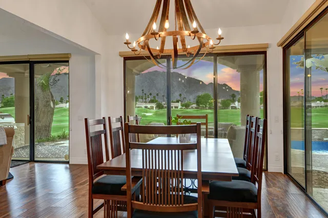 a view of a dining room with furniture wooden floor and chandelier