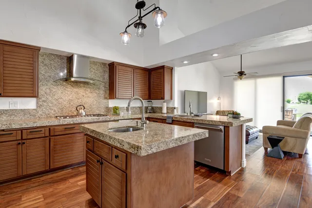 a kitchen with a sink stove and wooden cabinets
