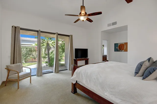 a bed room with a bed and a chair