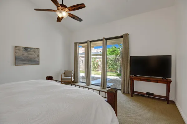 a bedroom with a bed and a flat screen tv