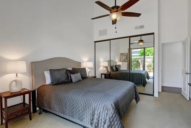 a bedroom with a large bed and a window