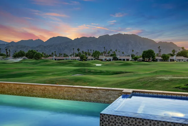a view of a grassy field with mountain