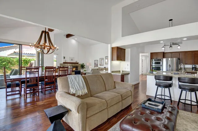 a living room with furniture fireplace and a large window