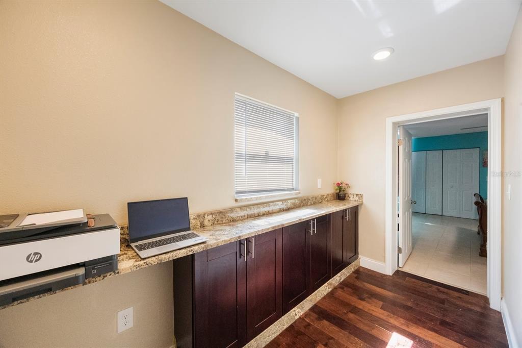 3336 20th Avenue Southwest Largo, FL 33774 - Photo 12 of 37 a kitchen with stainless steel appliances granite countertop a sink and a refrigerator