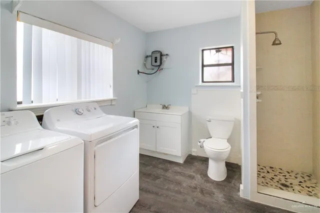 a view of bathroom with a sink toilet and a window
