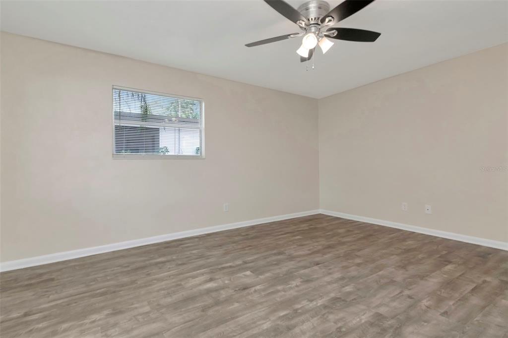 126 Kingsway Road Brandon, FL 33510 - Photo 10 of 42 a view of an empty room with window and wooden floor