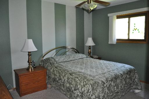 516 Spruce Road Bolingbrook, IL 60440 - Photo 7 of 16 a bedroom with a bed and a chandelier