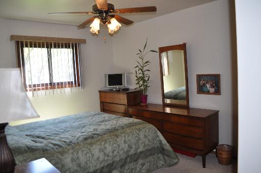 516 Spruce Road Bolingbrook, IL 60440 - Photo 8 of 16 a bedroom with a bed and a television