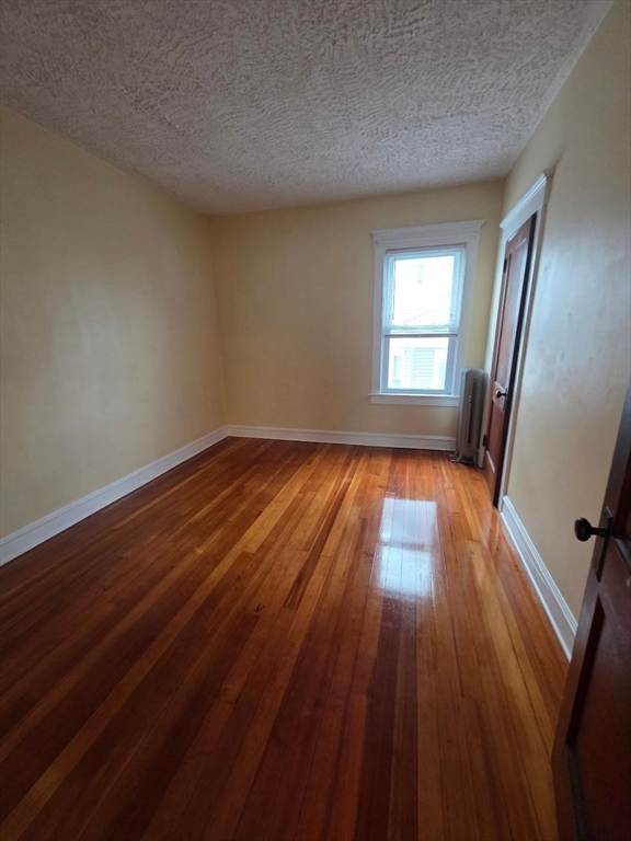 362 Pearce Street, Unit 2 Fall River, MA 02720 - Photo 21 of 24 wooden floor in an empty room with a window