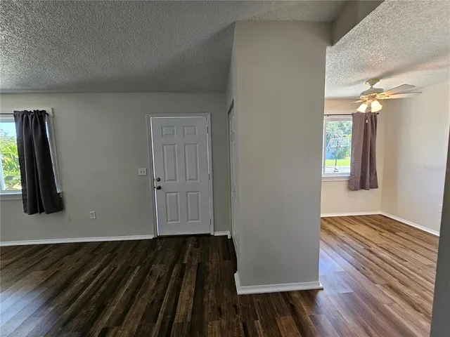 a view of an empty room and wooden floor