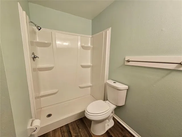 a view of a room with wooden floor