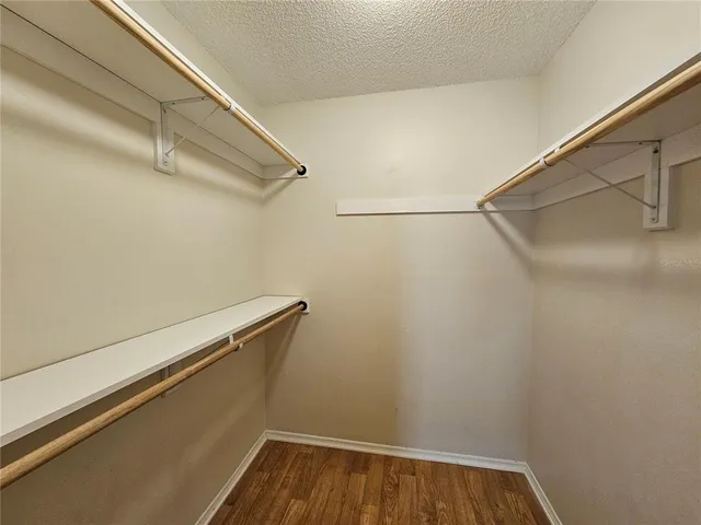 a view of room with wooden floor and ceiling fan