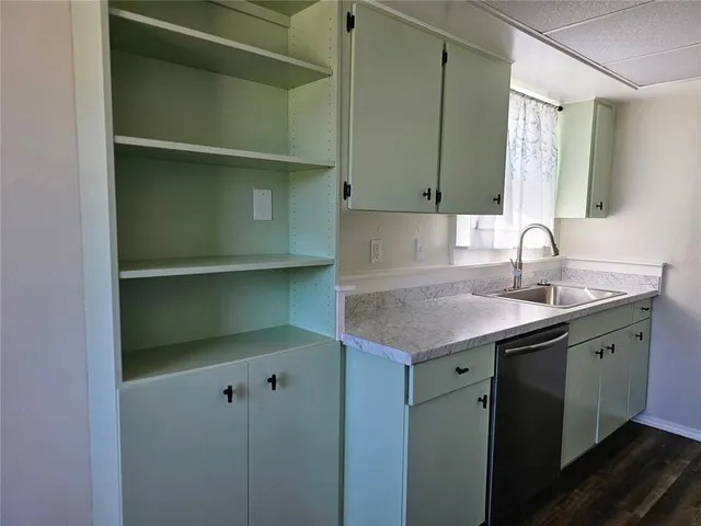 a kitchen with a sink stove and cabinets