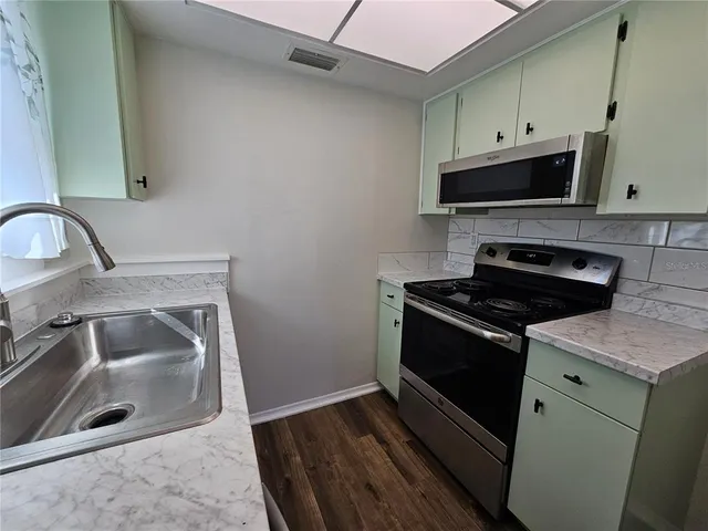 a kitchen with a stove microwave and refrigerator