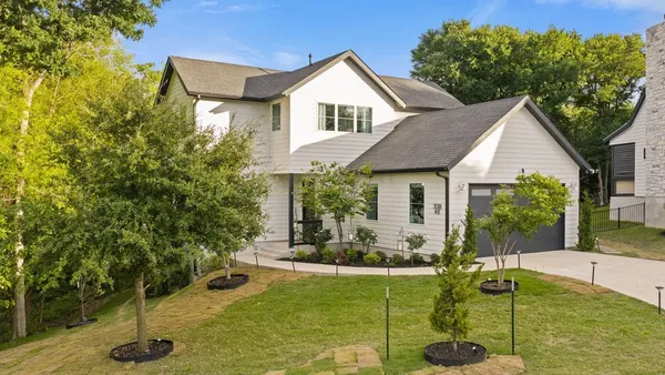 a living room with furniture a fireplace a flat screen tv and a large window