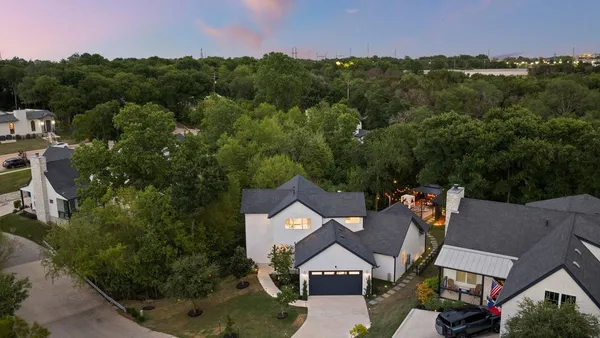 a living room with furniture a fireplace and a floor to ceiling window