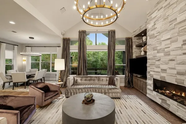 a kitchen with stainless steel appliances a stove a sink a oven a dining table and chairs