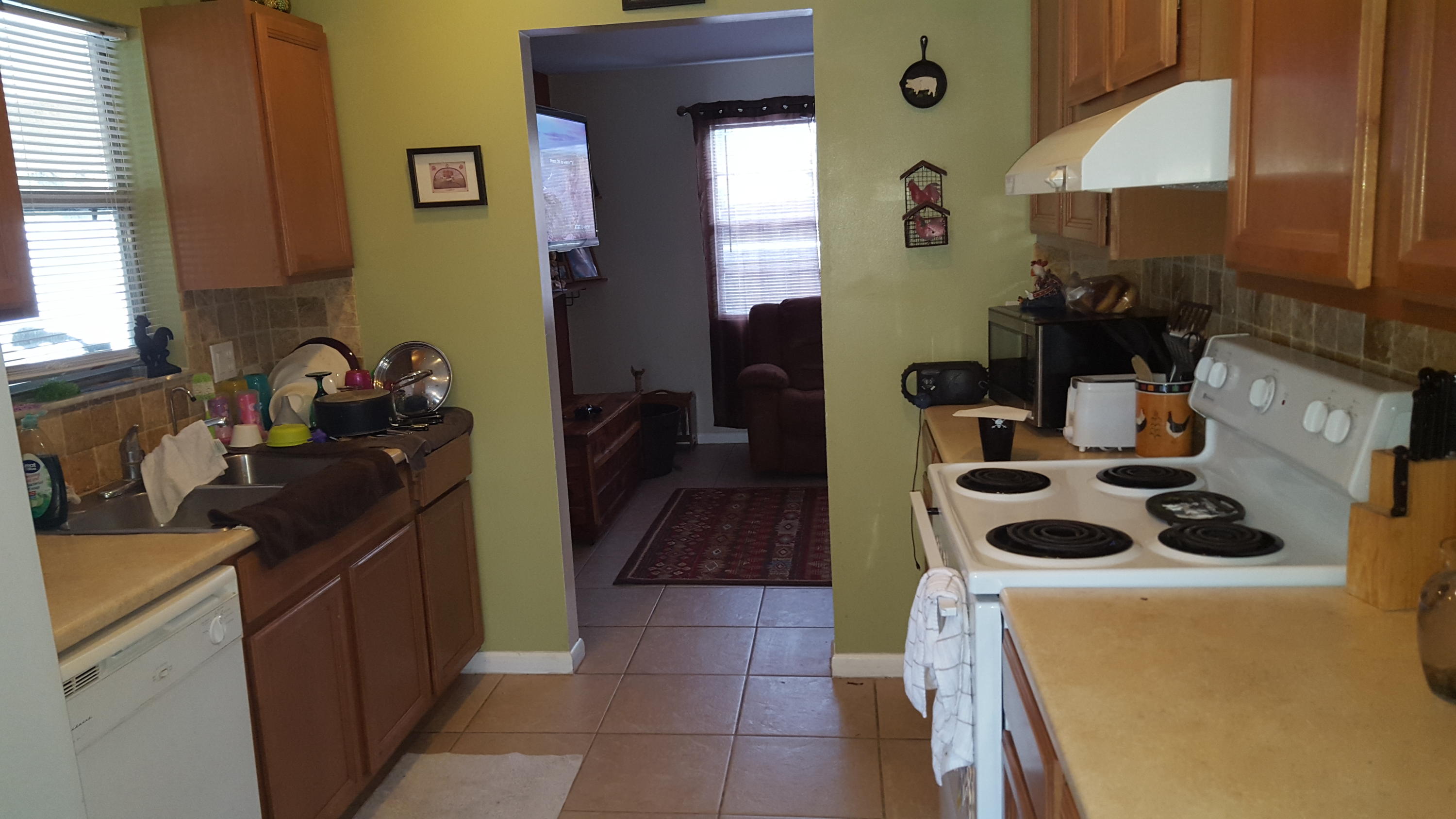 6459 Bischoff Road West Palm Beach, FL 33413 - Photo 6 of 12 a kitchen with a sink cabinets and a stove top oven