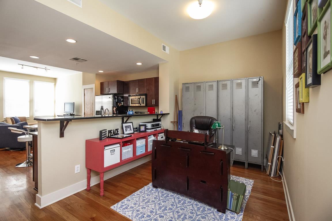 508 Madison Street, Unit 2 Nashville, TN 37208 - Photo 11 of 25 a living room with furniture a fireplace and a flat screen tv