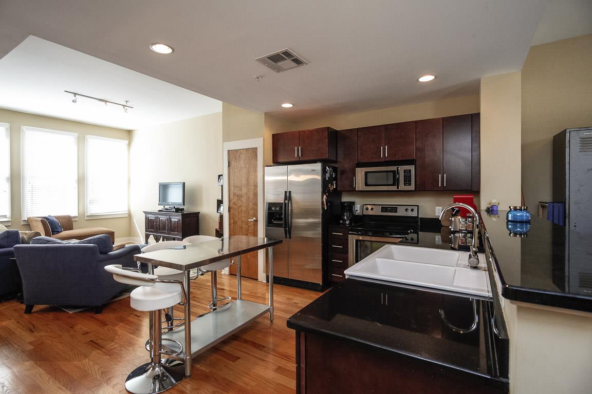 508 Madison Street, Unit 2 Nashville, TN 37208 - Photo 10 of 25 a kitchen with a refrigerator and a stove top oven