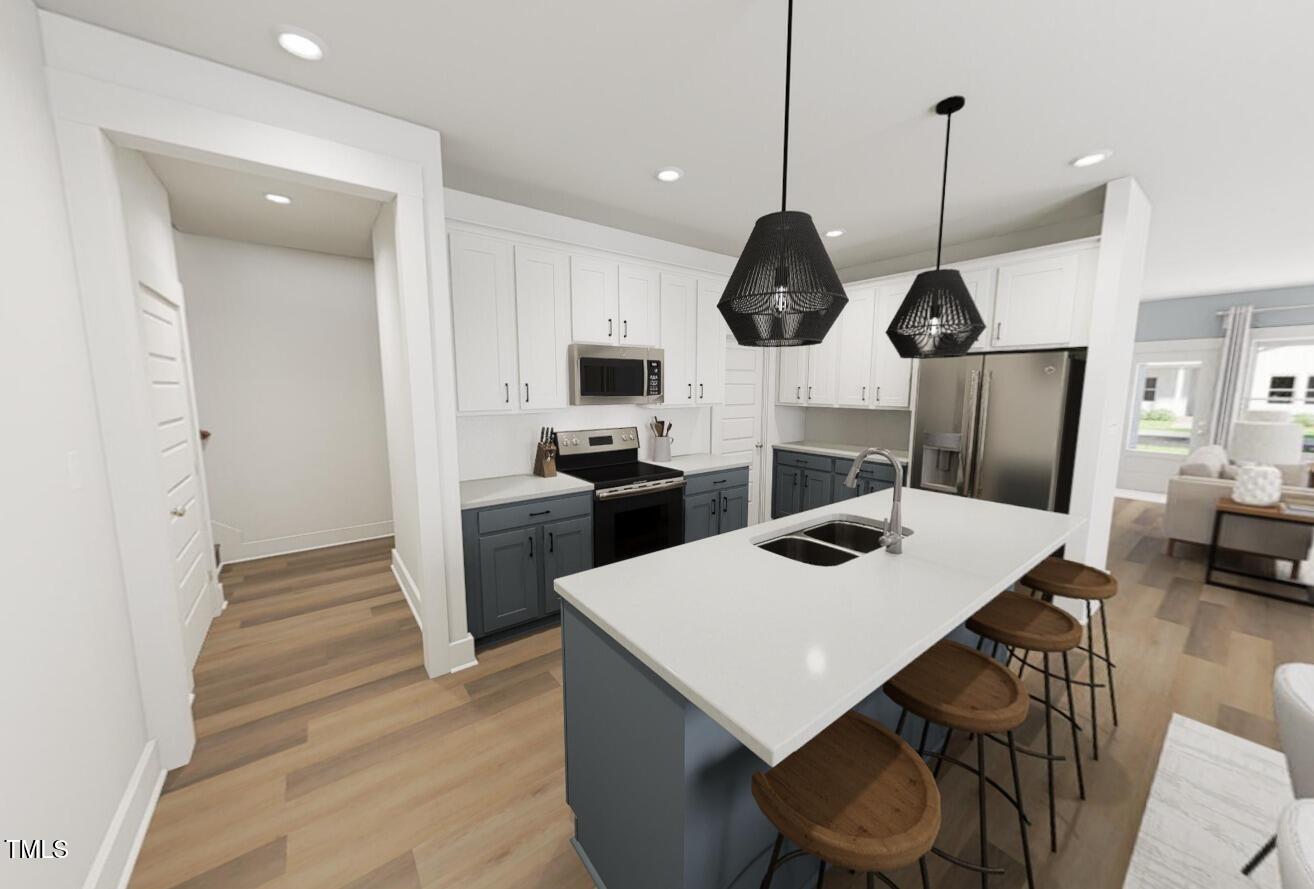 3929 Willow Gate Way Raleigh, NC 27604 - Photo 7 of 11 Kitchen with large island - the door on the back left goes to the 2-car attached garage! *these are renderings of the I Got Chills floorplan - options can vary with each home