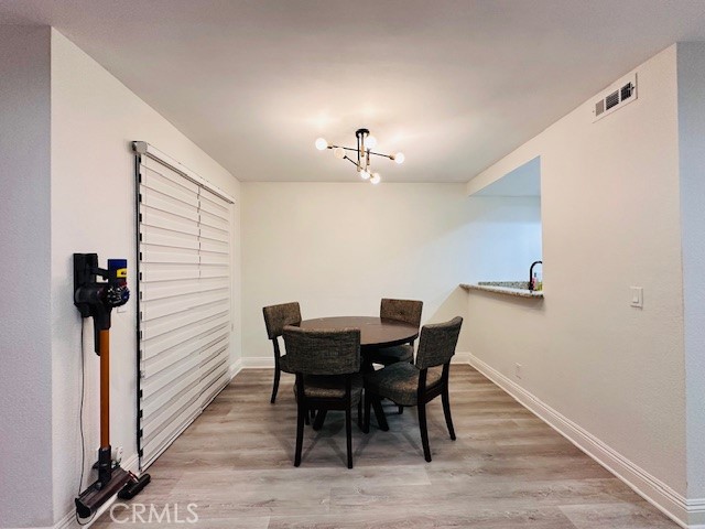4969 Embassy Way, Unit 6 Cypress, CA 90630 - Photo 5 of 19 a view of a dining room with furniture and wooden floor
