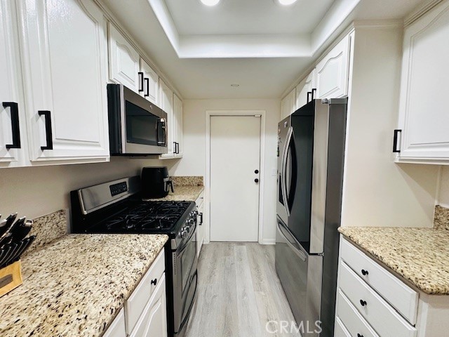 4969 Embassy Way, Unit 6 Cypress, CA 90630 - Photo 9 of 19 a kitchen with a refrigerator stove and sink