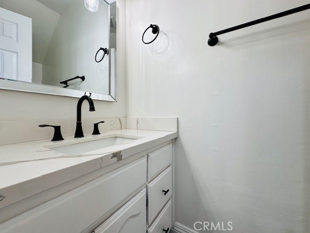 4969 Embassy Way, Unit 6 Cypress, CA 90630 - Photo 10 of 19 a bathroom with a sink and vanity