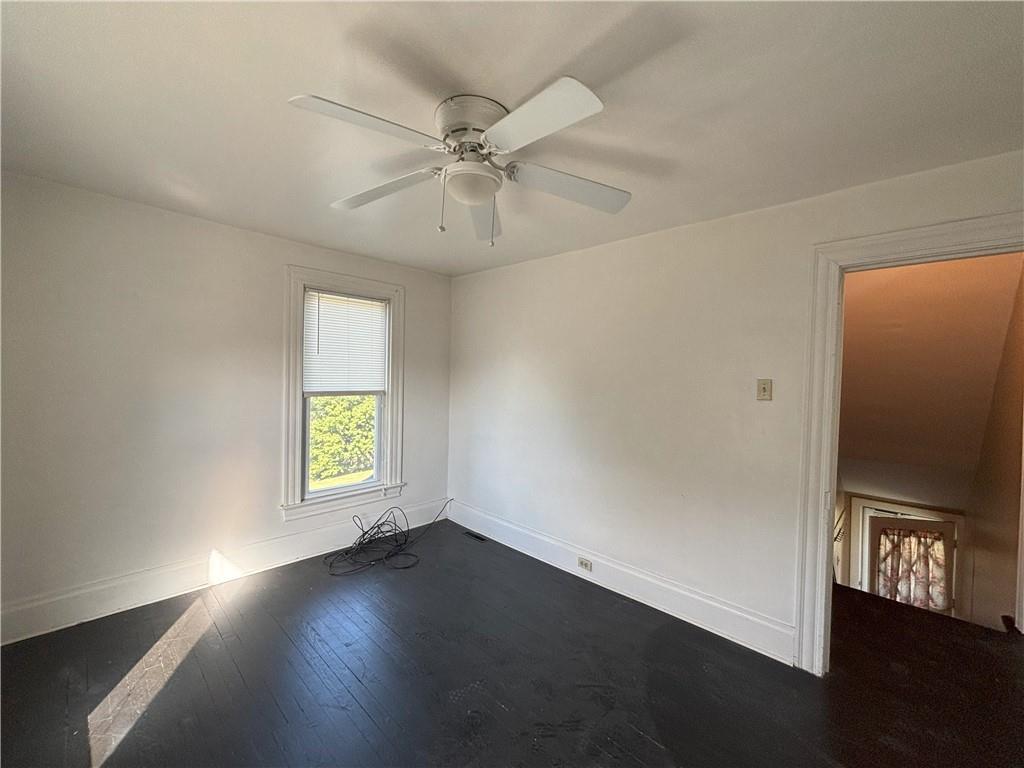 213 Franklin Street, Unit 2 Ligonier, PA 15658 - Photo 11 of 27 an empty room with wooden floor fan and windows