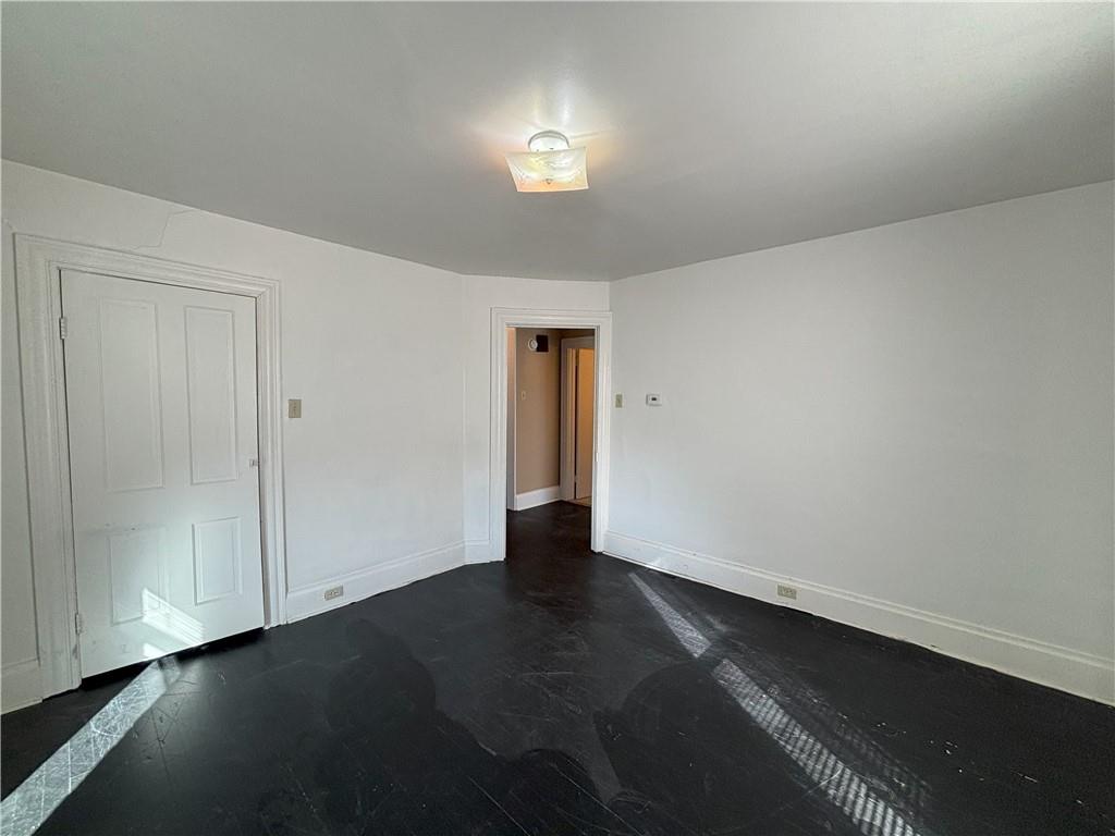 213 Franklin Street, Unit 2 Ligonier, PA 15658 - Photo 13 of 27 an empty room with wooden floor and windows
