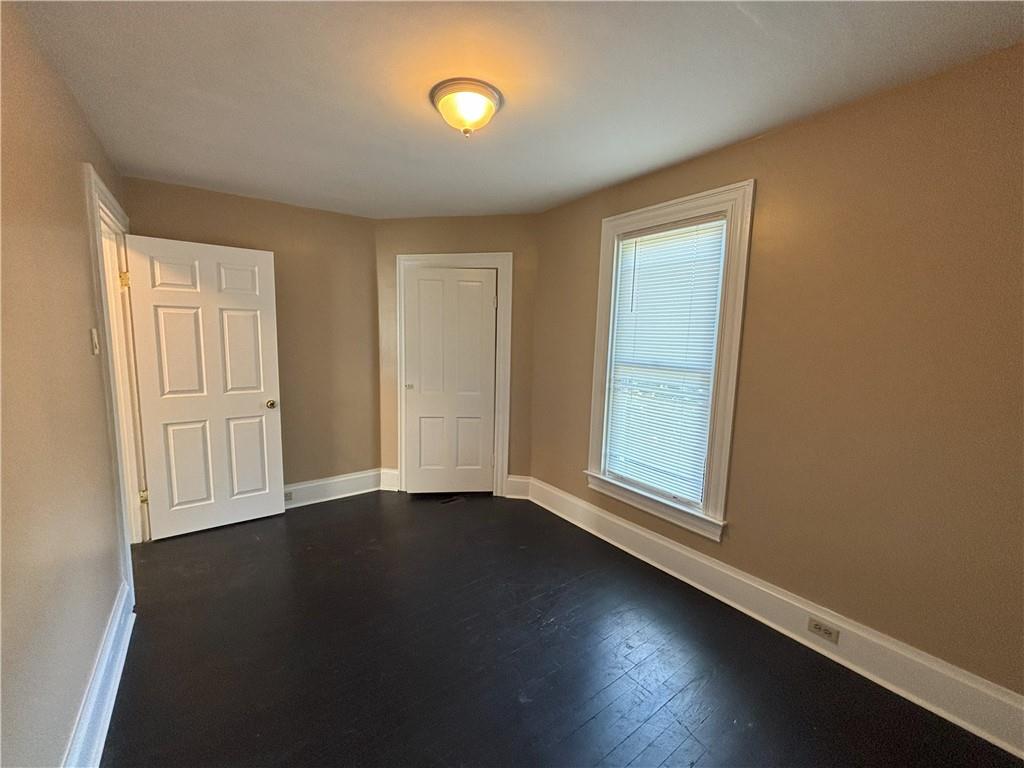 213 Franklin Street, Unit 2 Ligonier, PA 15658 - Photo 16 of 27 an empty room with wooden floor and windows