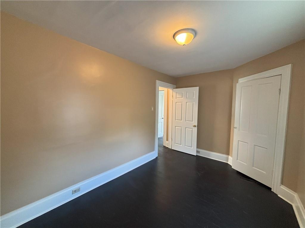 213 Franklin Street, Unit 2 Ligonier, PA 15658 - Photo 17 of 27 a view of an empty room with wooden floor and a window