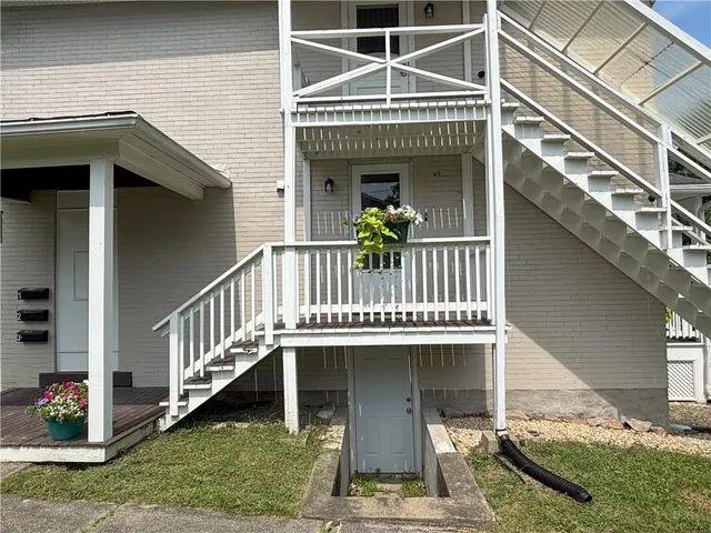a view of small house with yard and furniture