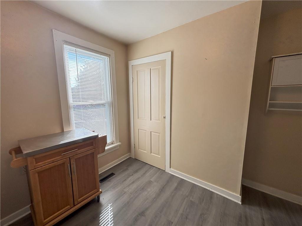 213 Franklin Street, Unit 2 Ligonier, PA 15658 - Photo 8 of 27 an empty room with wooden floor and windows