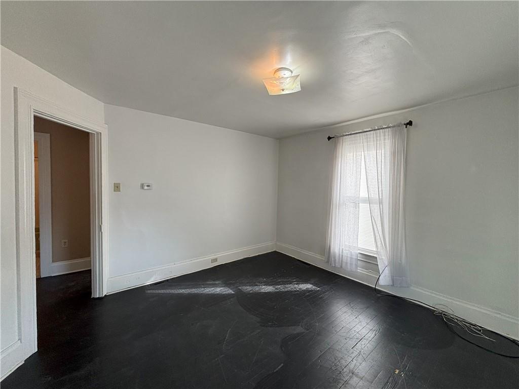 213 Franklin Street, Unit 2 Ligonier, PA 15658 - Photo 10 of 27 an empty room with wooden floor and windows