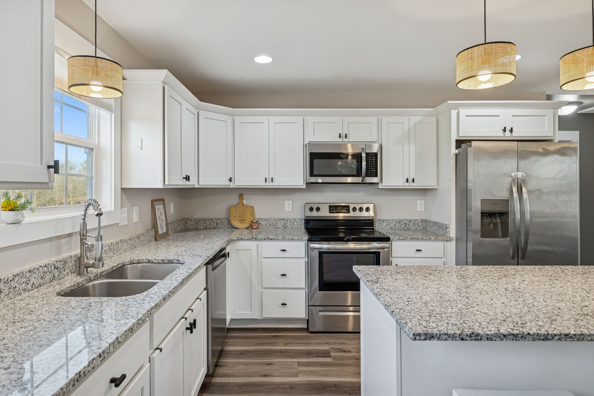 1521 Wixtown Road Westmoreland, TN 37186 - Photo 10 of 33 a kitchen with stainless steel appliances granite countertop a sink a stove a refrigerator a center island a stove and a counter space