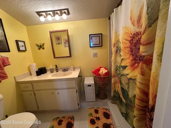 a bathroom with a sink and mirror with toilet