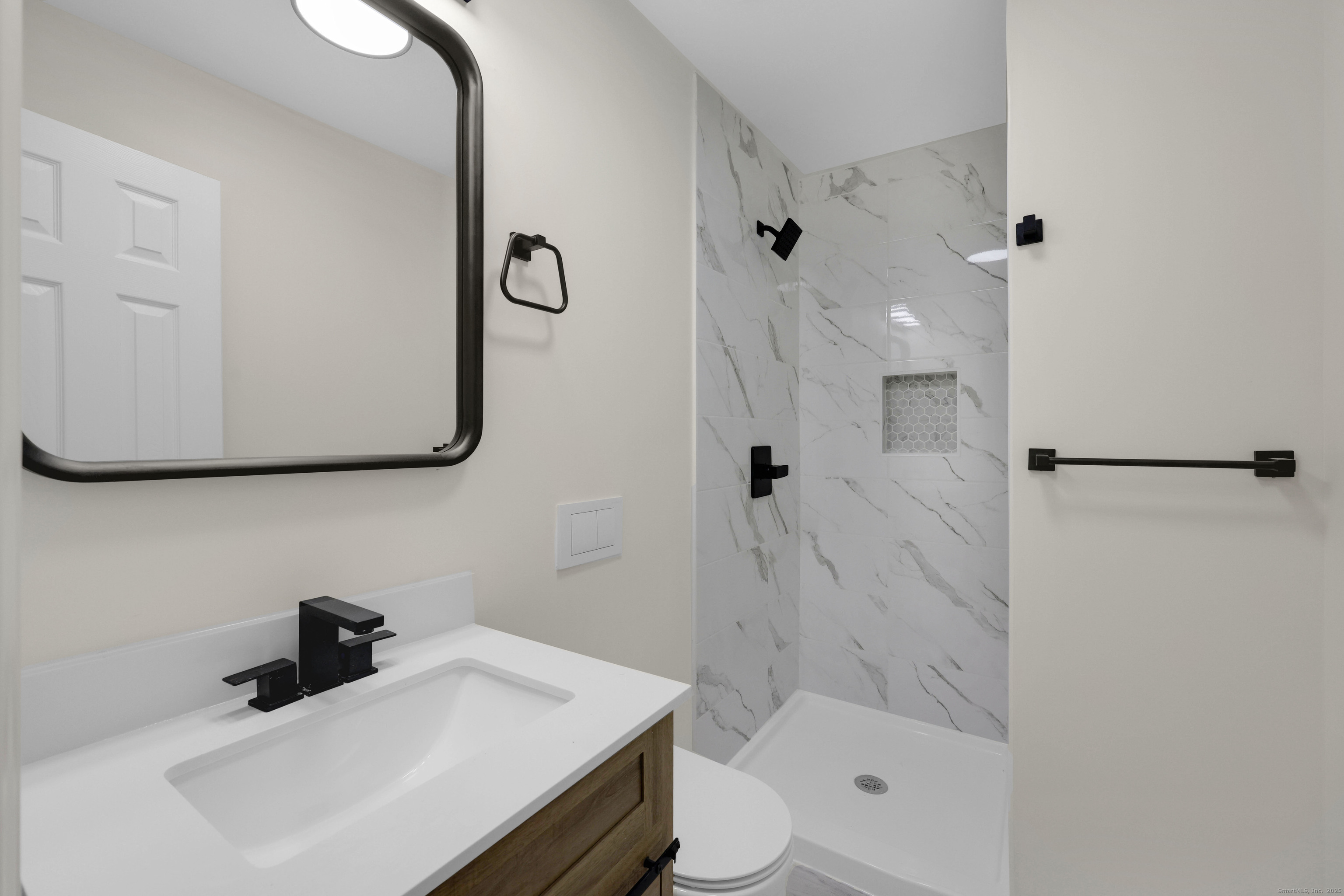 2064 Long Hill Road Guilford, CT 06437 - Photo 20 of 28 a bathroom with a sink a toilet and shower