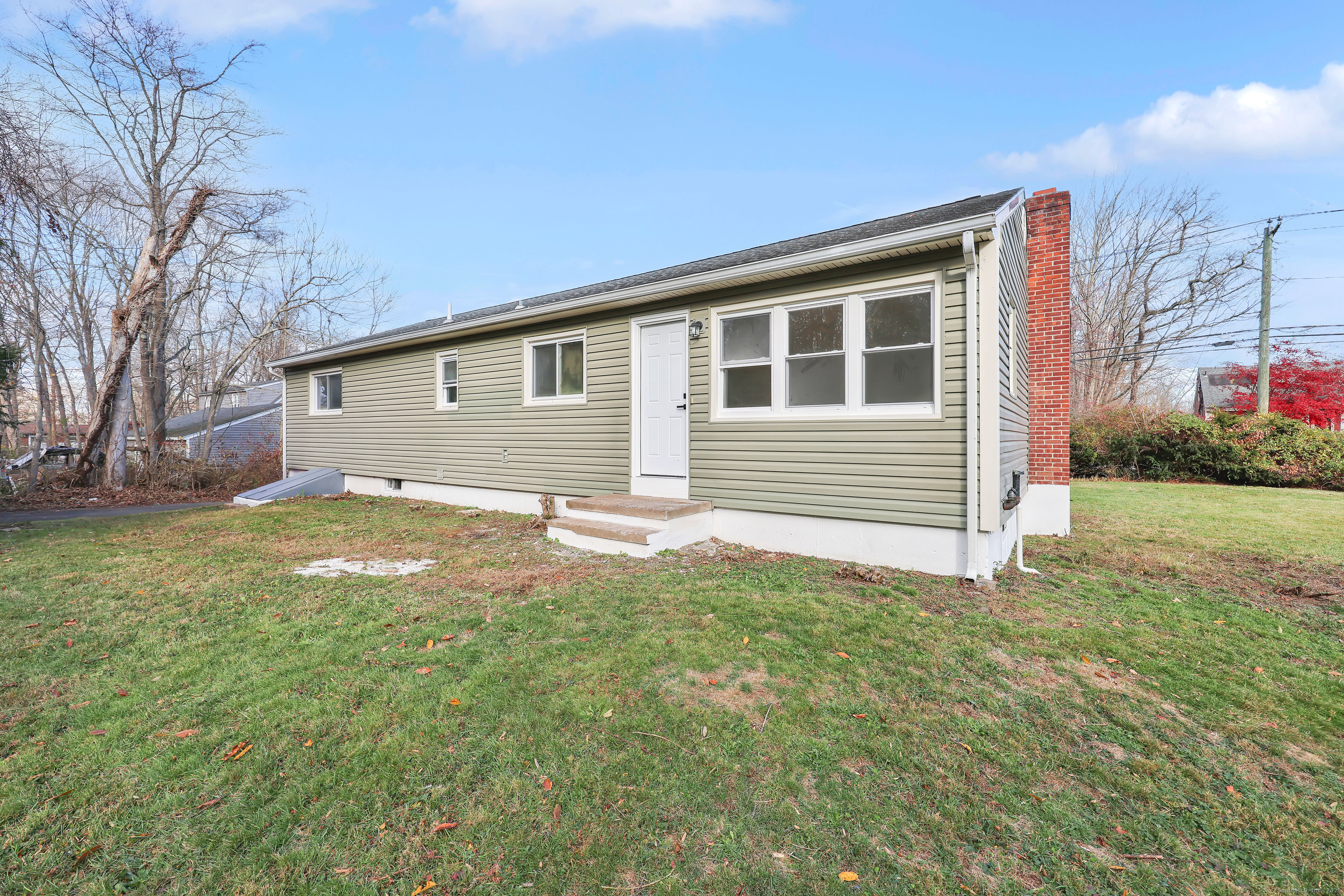 2064 Long Hill Road Guilford, CT 06437 - Photo 27 of 28 a front view of a house with a garden