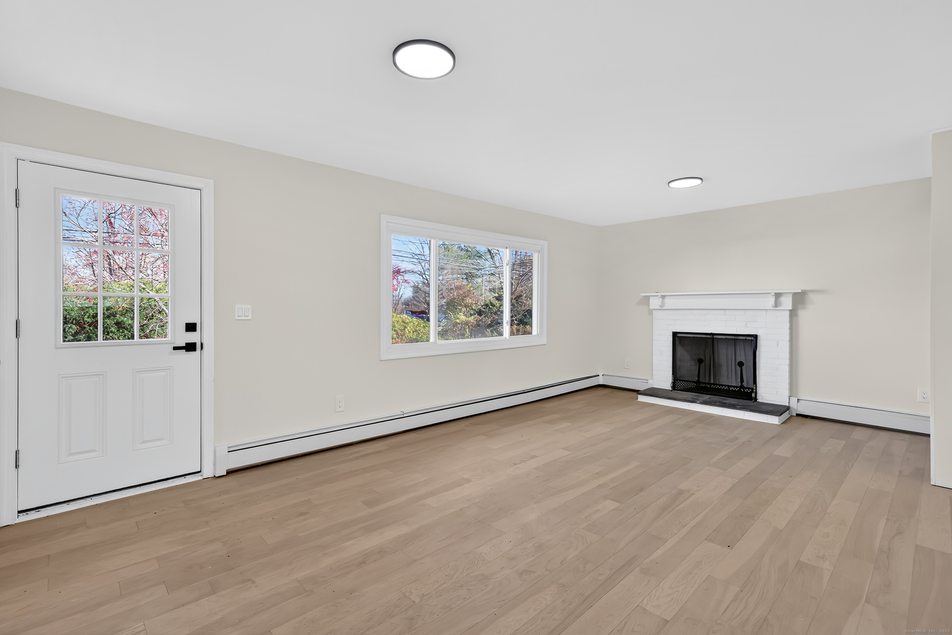 2064 Long Hill Road Guilford, CT 06437 - Photo 3 of 28 an empty room with windows and fireplace