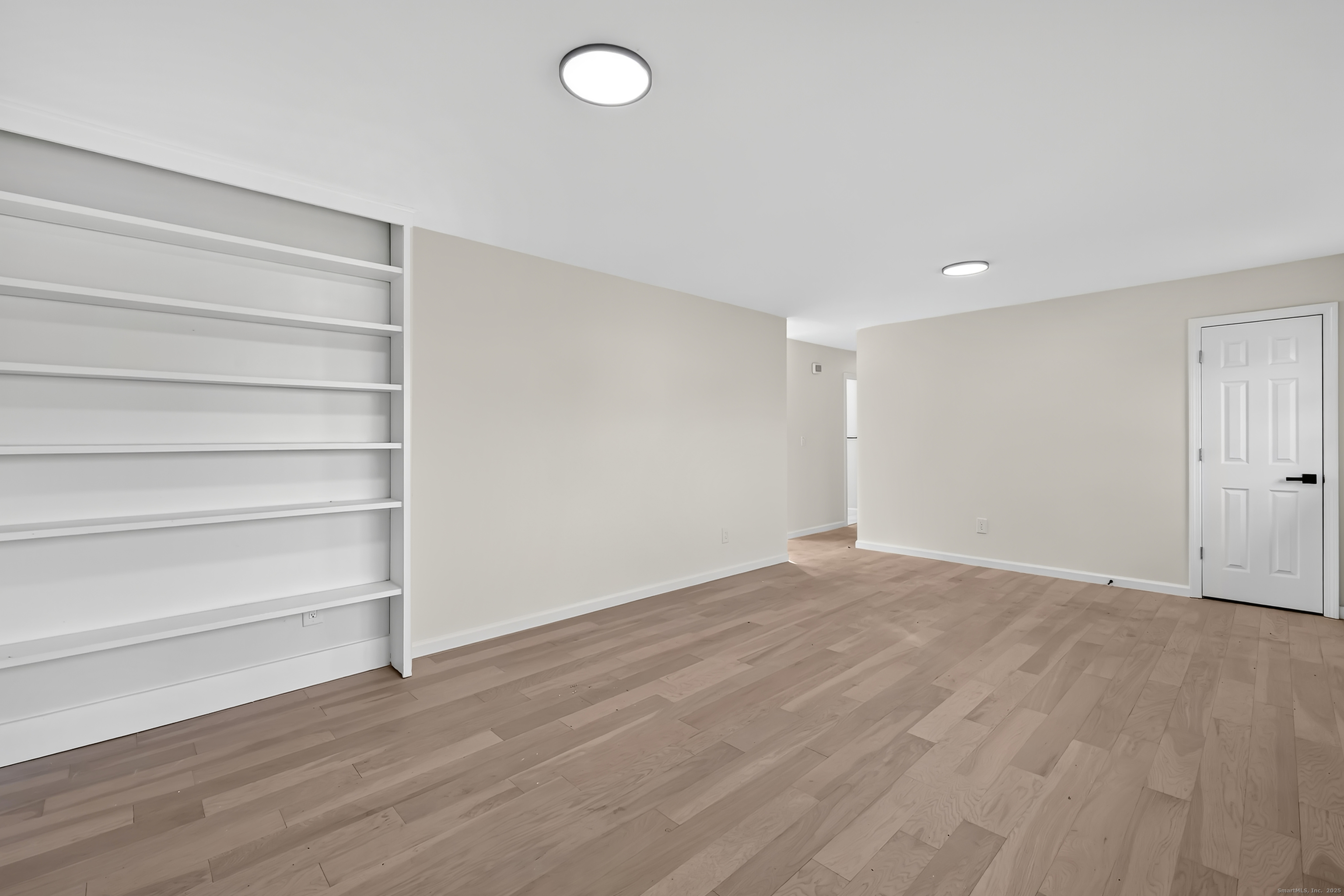 2064 Long Hill Road Guilford, CT 06437 - Photo 6 of 28 a view of an empty room with a window and wooden floor