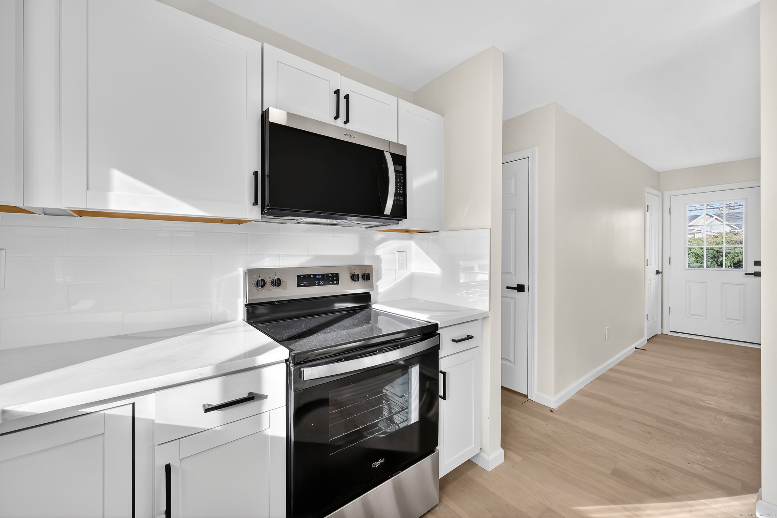 2064 Long Hill Road Guilford, CT 06437 - Photo 10 of 28 a kitchen with cabinets stainless steel appliances and wooden floor
