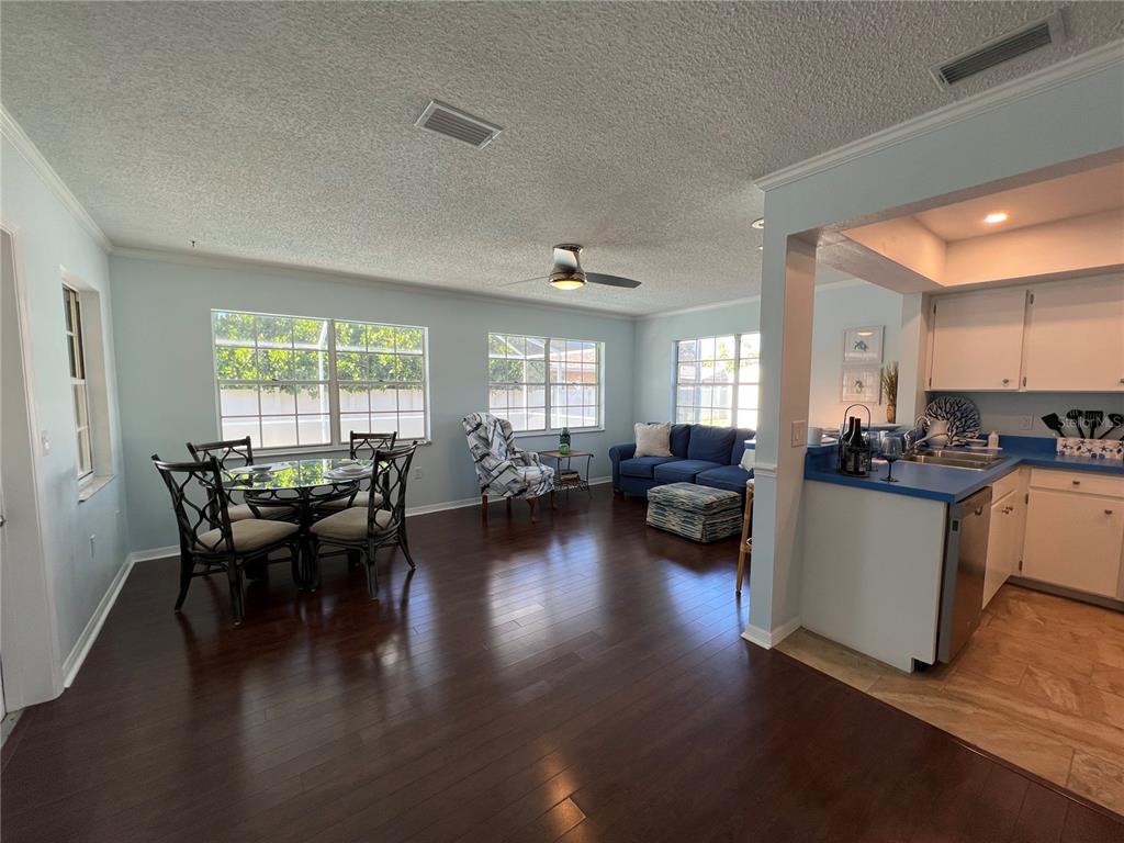 1536 Porpoise Road Venice, FL 34293 - Photo 12 of 33 a living room with couches and kitchen view with wooden floor