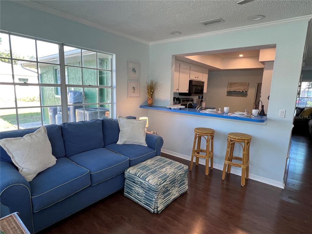1536 Porpoise Road Venice, FL 34293 - Photo 14 of 32 a living room with furniture and a wooden floor