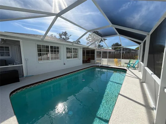 a view of a house with a backyard porch and sitting area