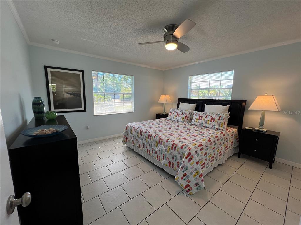 1536 Porpoise Road Venice, FL 34293 - Photo 21 of 33 a bedroom with a bed and a lamp
