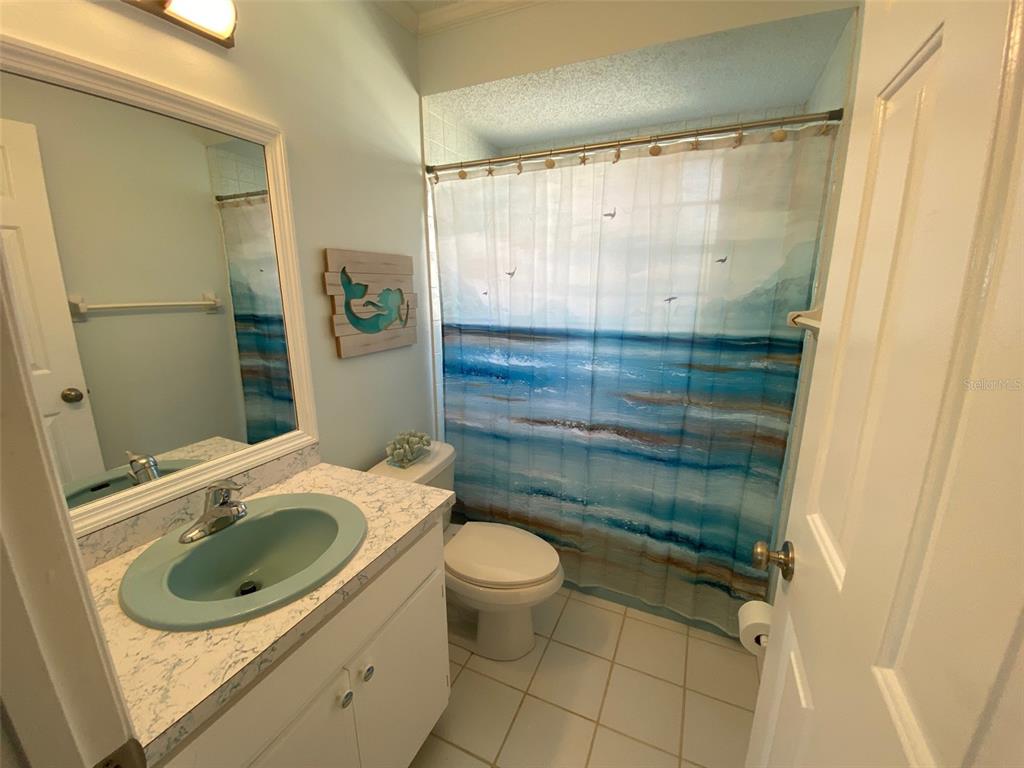 1536 Porpoise Road Venice, FL 34293 - Photo 27 of 33 a bathroom with a sink toilet and shower