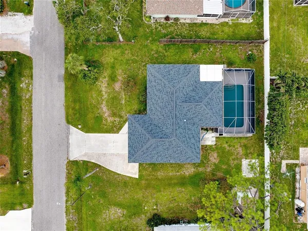an aerial view of a house with a yard