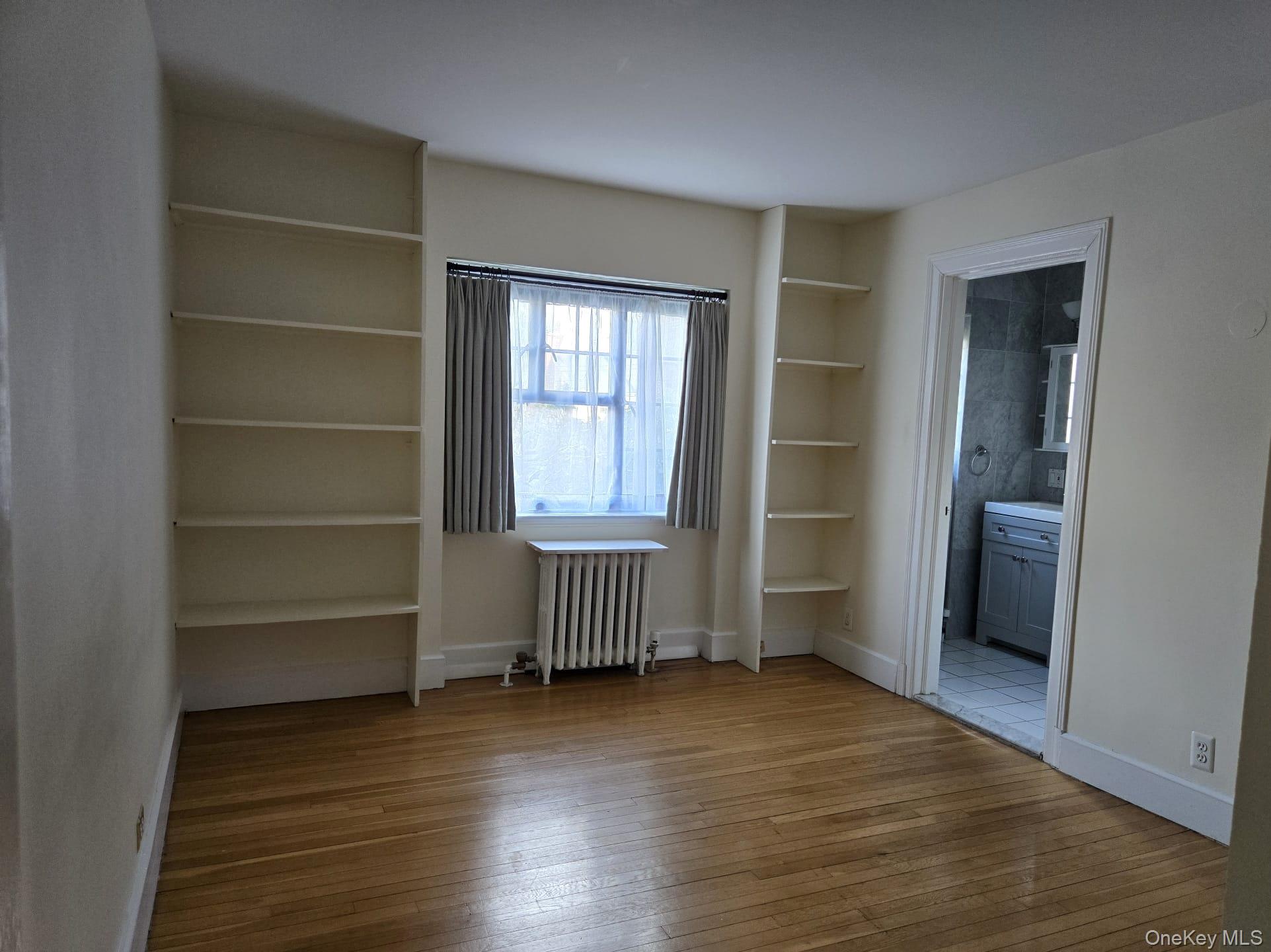 6 Davis Avenue, Unit A11 Rye, NY 10580 - Photo 15 of 23 Ample Bedroom with bookshelves and window.