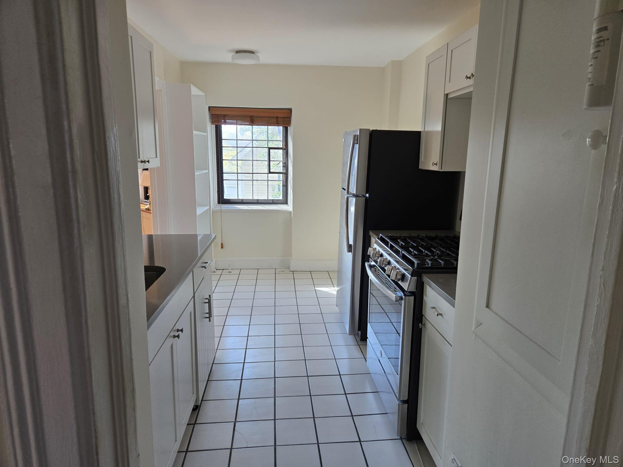 6 Davis Avenue, Unit A11 Rye, NY 10580 - Photo 4 of 23 View of kitchen from entrance hall.